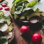 sliced cucumber and red tomato on brown wooden chopping board