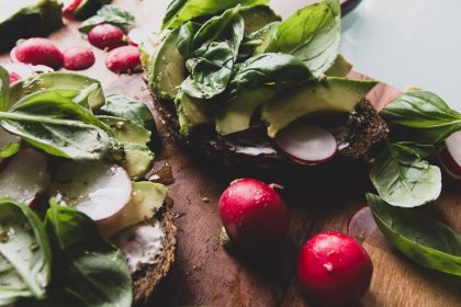 sliced cucumber and red tomato on brown wooden chopping board